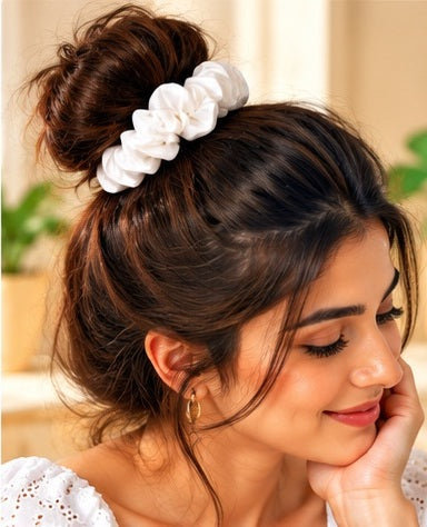  Woman wearing a white scrunchie in a high bun hairstyle
