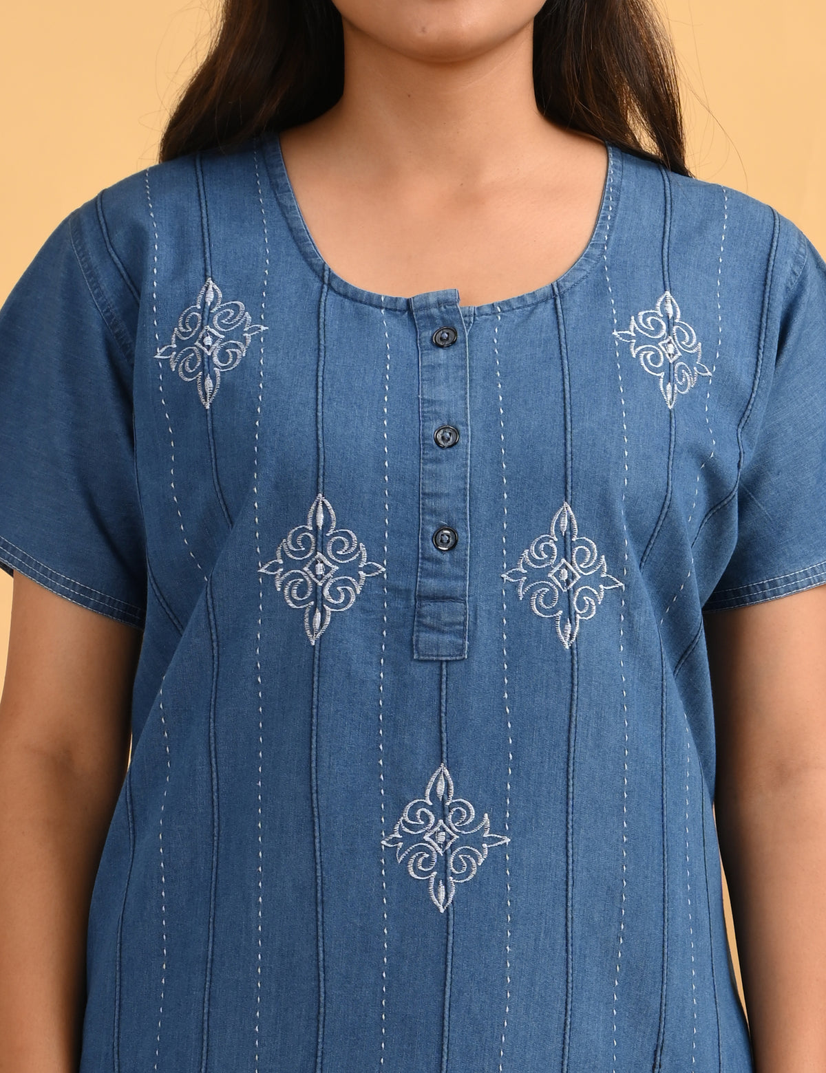 Close-up of white embroidered detailing on the light blue cotton denim nighty from Jammies Haven