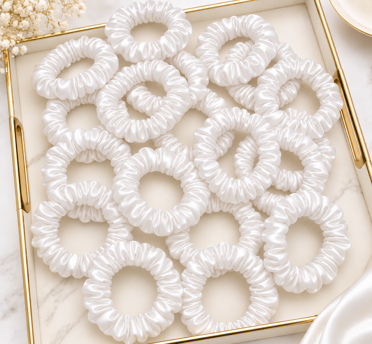 Pack of white slim hair scrunchies arranged in a tray