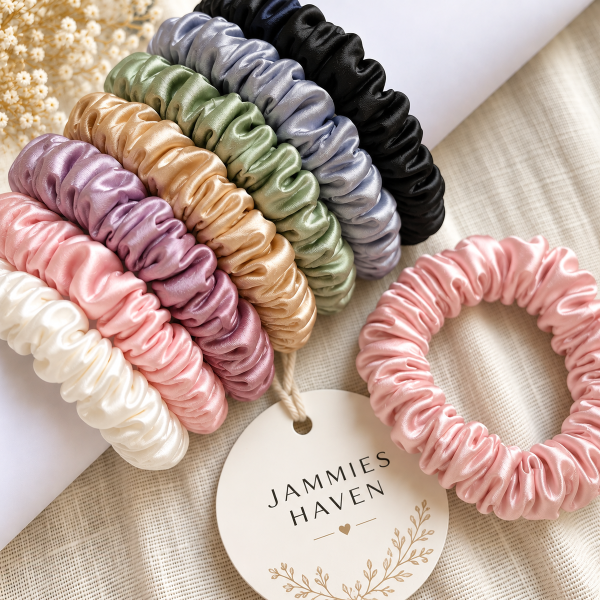 Multicolor slim satin hair scrunchies arranged in a row